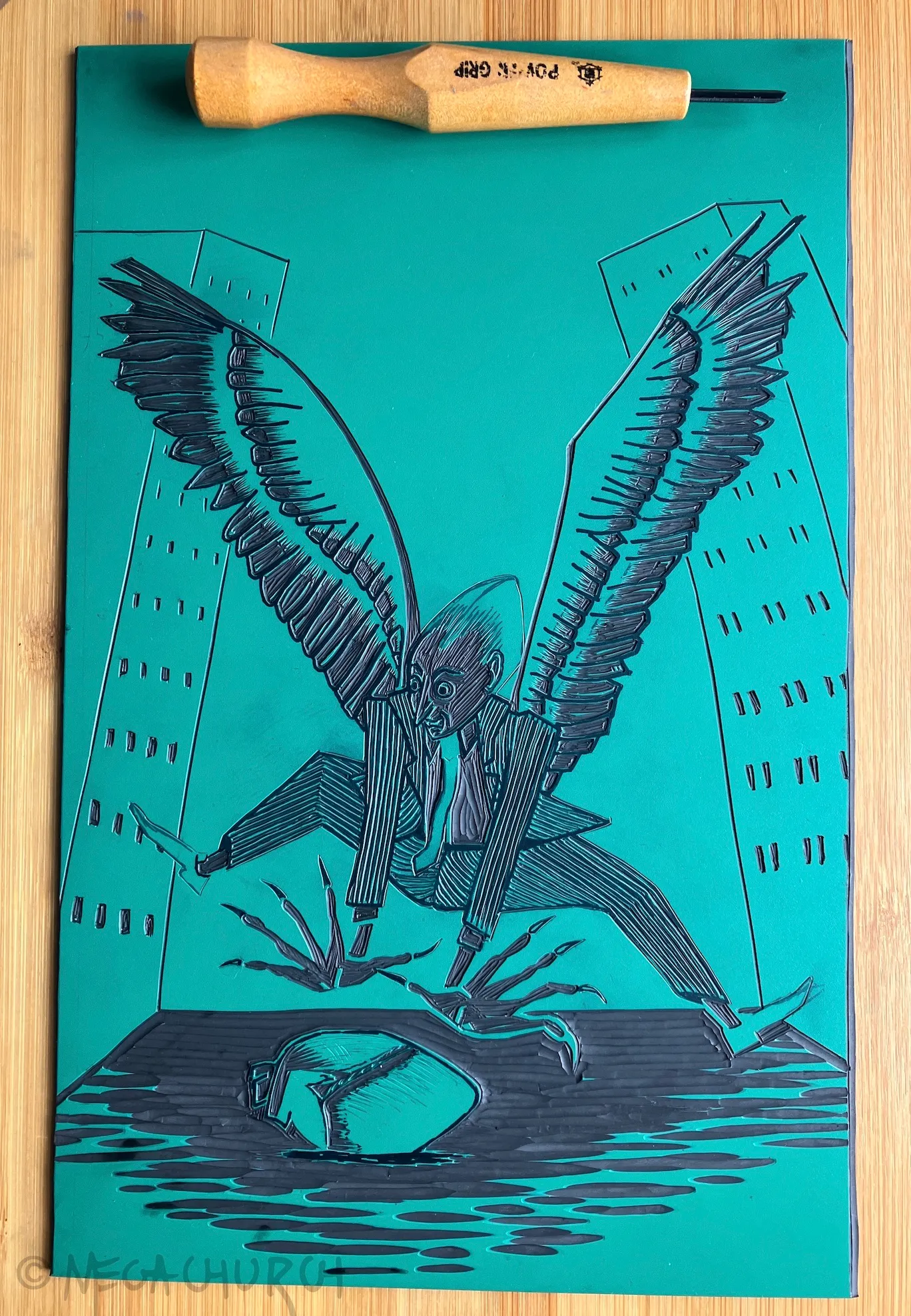 A partially inked vinyl plate into which the Bird of Prey print has been carved, alongside a brayer.