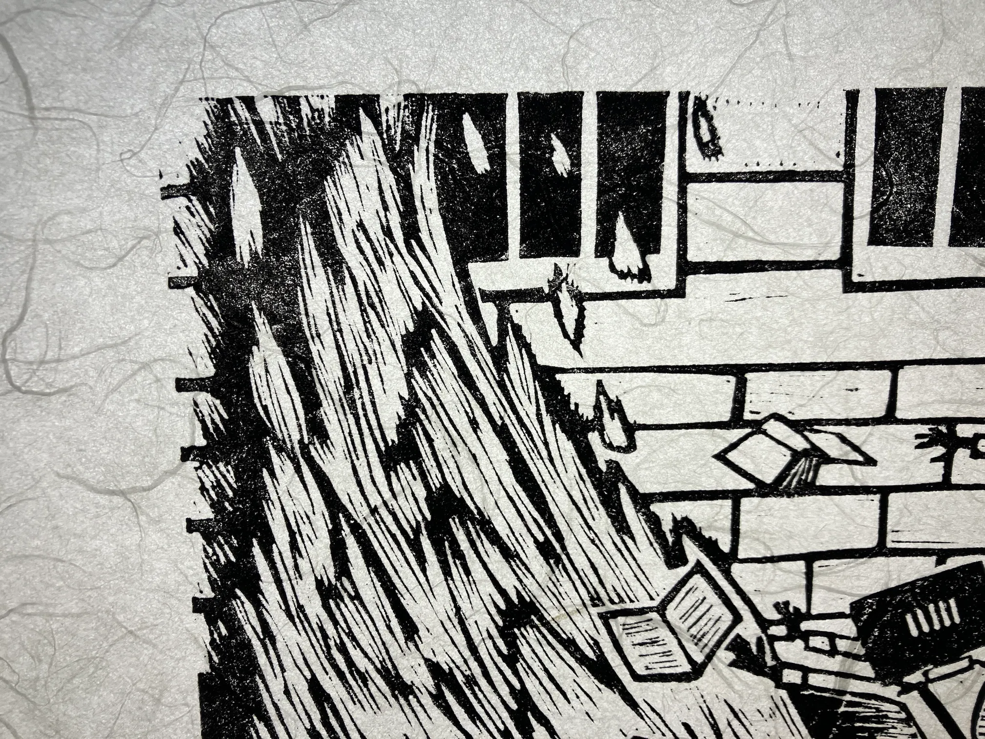 A close-up of the The End of Literacy print when backlit, showing the textured fibers of the paper.