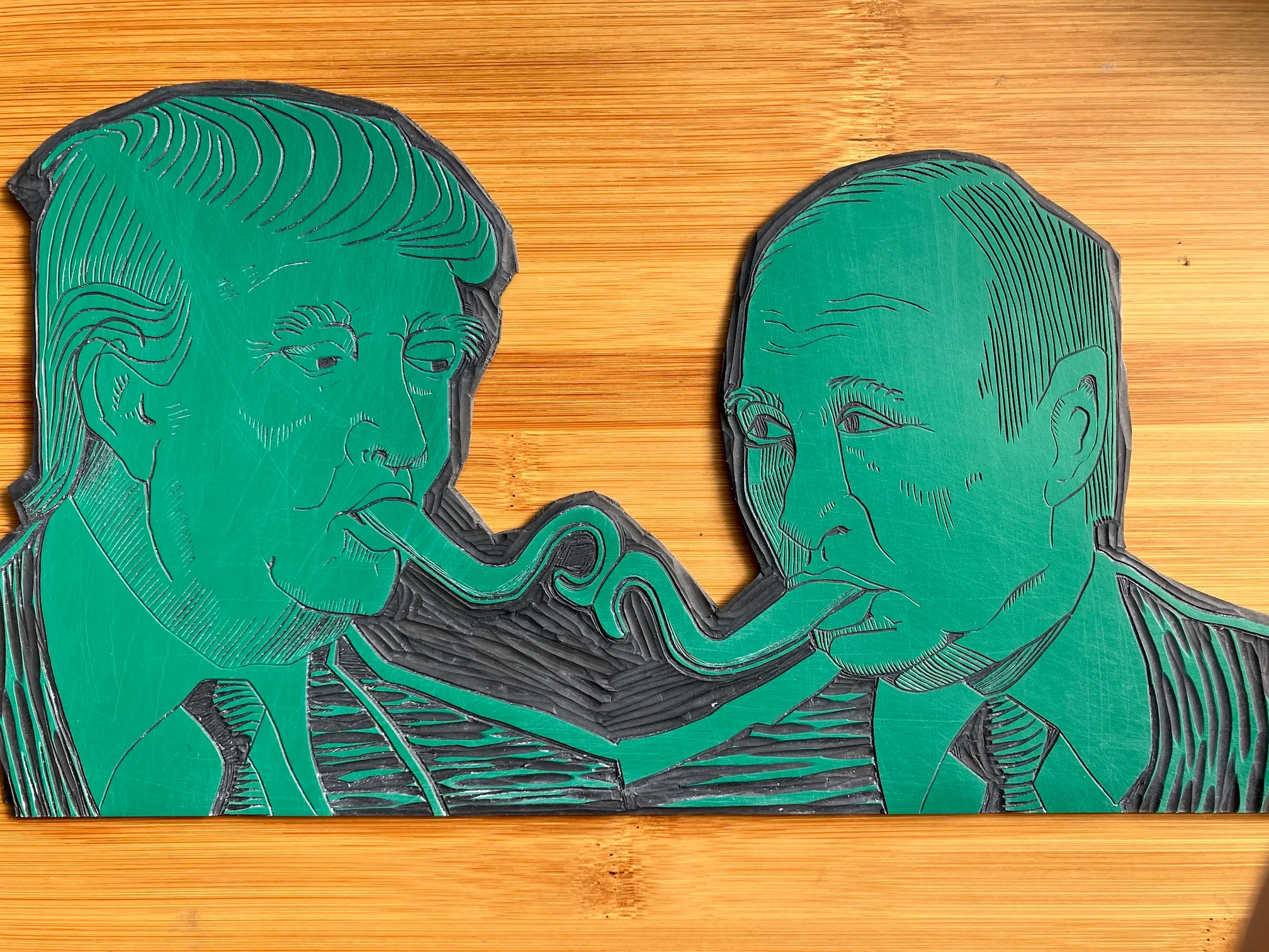 A vinyl plate into which the Trump-Putin Kissy Kiss image has been carved out.