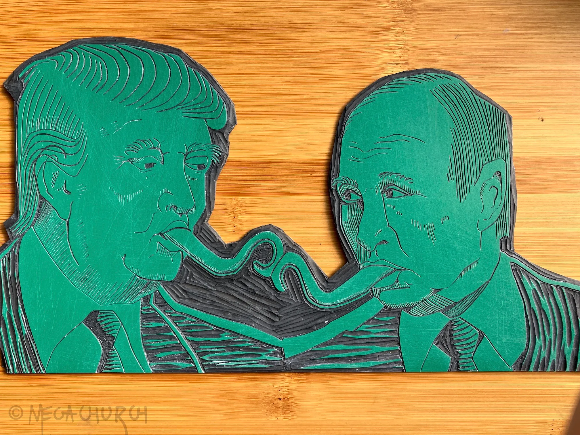 A vinyl plate into which the Trump-Putin Kissy Kiss image has been carved out.