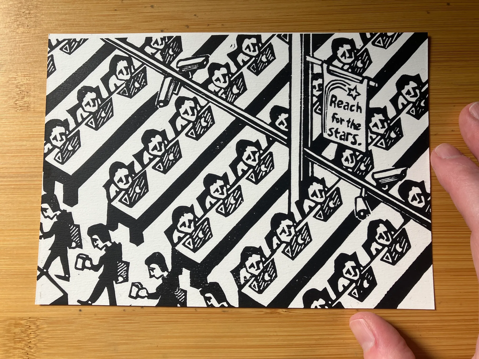 A relief print of rows of identical, sad-looking workers sitting in front of computers. There are surveillance cameras in the rafters and a banner that reads "Reach for the Stars".